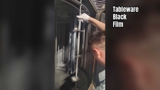 Stainless steel tableware coated with a black film